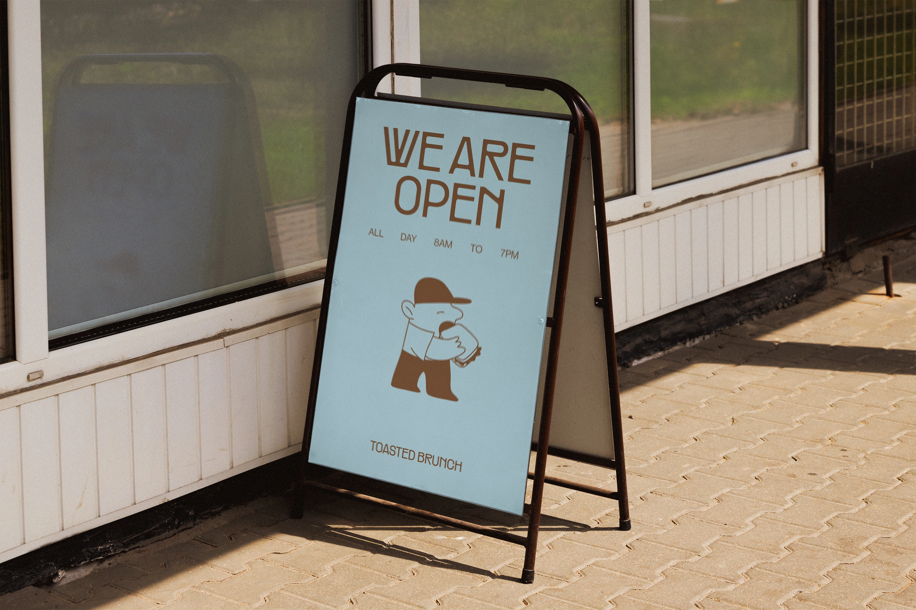 Cartel We are open de Toasted Brunch en la puerta